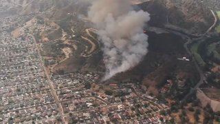A brush fire was burning Tuesday June 10, 2025 in the hills above Burbank.